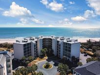 Gorgeous aerial view of ocean-front condo building with access to the beach and beautiful ocean views at 417 South Dunes Dr. # B16, Pawleys Island, SC 29585