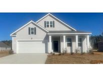 Charming single-Gathering home featuring a 2-car garage, a covered front porch, and classic architectural details at 418 Glade Ct., Loris, SC 29569