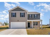Charming two-story home featuring a two-car garage and a beautifully landscaped front yard at 426 Glade Ct., Loris, SC 29569