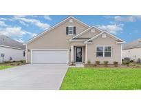 Charming single-Gathering home featuring a two-car garage and a well-manicured lawn at 447 Clear Lake Dr., Conway, SC 29526