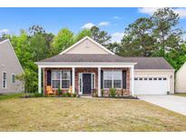 Charming brick home with a welcoming front porch and well-maintained lawn, featuring two wooden chairs at 4697 Farm Lake Dr., Myrtle Beach, SC 29579