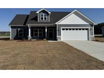 Charming single-Gathering home with a two-car garage, dormer window, and well-maintained lawn in a suburban neighborhood at 4963 Dupont Rd., Aynor, SC 29511