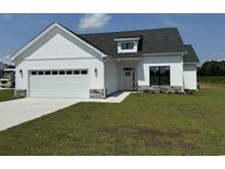 Charming new construction home featuring a two-car garage and beautifully manicured lawn at 4971 Dupont Rd., Aynor, SC 29511