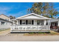 Charming single-story home with a welcoming porch and a well-maintained exterior with black shutters at 6001- 1776 S Kings Highway, Myrtle Beach, SC 29575