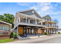 Two-story coastal home featuring a covered porch, ground-level parking, and durable gray siding at 6001- 5432 S Kings Highway, Myrtle Beach, SC 29575