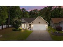 Charming single story home featuring a two-car garage and a well-maintained lawn at 6465 Royal Pine Dr., Myrtle Beach, SC 29588