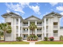 Beautiful condo with three floors of balconies and manicured landscaping featuring tropical palm trees at 673 Tupelo Ln. # G, Longs, SC 29568