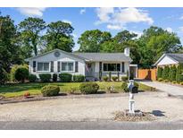 Charming single-story home featuring a well-manicured lawn and attractive landscaping with a gravel driveway at 709 Yucca Ave., Myrtle Beach, SC 29577