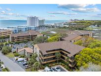 Scenic aerial view of the condo complex near the ocean, parking and landscaping at 9501 Shore Dr. # C-328, Myrtle Beach, SC 29572