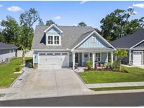 Charming two-story home with light blue siding, an attached two-car garage, and well-manicured landscaping at 1010 Graybill Lane, North Myrtle Beach, SC 29582