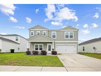 Charming two-story home with landscaped yard and inviting curb appeal at 1015 Saltgrass Way, Myrtle Beach, SC 29588