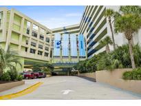 Inviting entrance to Coral Beach Resort with covered drive, convenient parking, and lush landscaping at 1105 S Ocean Blvd. # 630, Myrtle Beach, SC 29577