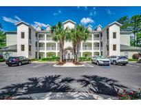Inviting condo building with palms, multiple levels, ample parking, and a manicured landscape at 116 Cypress Point Ct. # 302, Myrtle Beach, SC 29579