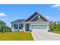 Charming single-story home with a well-manicured lawn, two-car garage and coastal curb appeal at 127 Emerald Rush Ct., Longs, SC 29568