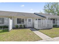 Charming condo featuring a front yard with a white picket fence and beautiful landscaping at 1391 Turkey Ridge Rd. # C, Surfside Beach, SC 29575