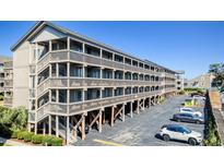 Exterior view of a multi-story building with parking, accessed by stairs at 204 Maison Dr. # N304, Myrtle Beach, SC 29572