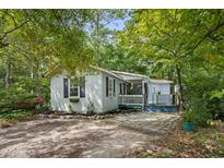 Charming single-story home with a cozy front porch and a well-maintained, landscaped yard at 2128 Adams Circle, Little River, SC 29566