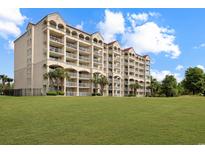 Beautiful multi-story building with arched balconies overlooking a pristine green lawn at 2151 Bridgeview Ct. # 3-405, North Myrtle Beach, SC 29582
