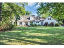 Charming home with a well-manicured lawn, mature trees, and a classic design at 217 Myrtle Ln., Myrtle Beach, SC 29572