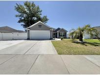 Charming single-story home with well-manicured lawn, gray siding, and a paved driveway at 2217 Belladora Rd., Conway, SC 29527