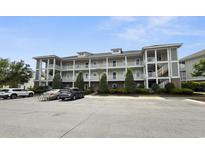 Inviting condo complex featuring multiple levels and exterior walkways and well-maintained landscaping at 224 Castle Dr. # 1408, Myrtle Beach, SC 29579
