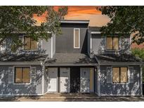 Charming townhouse exterior with gray siding, white doors, and manicured landscaping at 3700 Golf Colony Lane # 21 B, Little River, SC 29566
