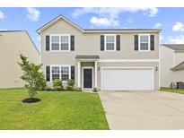 Charming two-story home with vinyl siding, black shutters, manicured lawn, and attached two-car garage at 4009 Alvina Way, Myrtle Beach, SC 29579