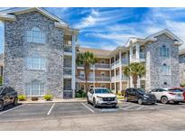 Beautiful condo complex featuring stone accents, covered balconies, and ample parking at 4741 Wild Iris Dr. # 303, Myrtle Beach, SC 29577