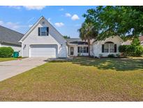 Charming home featuring a well-manicured lawn and a two-car garage and a large, mature tree at 5036 Billy K Trail, Myrtle Beach, SC 29579