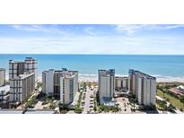 Expansive aerial view of oceanfront resort with tall buildings, a sunny beach, and ocean views at 5200 N Ocean Blvd. # 833, Myrtle Beach, SC 29577