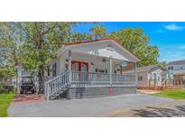 Charming single-story home with a red roof, a cozy front porch, and lush landscaping at 6001-5610 S Kings Hwy., Myrtle Beach, SC 29575