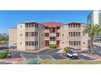 Attractive condo complex with multiple balconies, well maintained landscaping, and ample parking spaces at 609 Hillside Dr. S # C-16, North Myrtle Beach, SC 29582