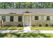 Charming single story home with well-manicured lawn and walkway leading to a front door with sidelight at 6734 Blue Heron Blvd. # 104, Myrtle Beach, SC 29588