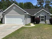 Charming single-story home with gray siding, attached garage, and well-maintained lawn at 753 Bucklin Loop, Myrtle Beach, SC 29579