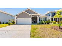 Charming single-story home featuring a well-manicured lawn and a two-car attached garage at 8077 Fort Hill Way, Myrtle Beach, SC 29579