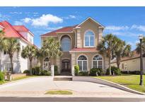 Two-story stucco home with well-manicured landscaping and a circular driveway at 837 Bluff View Dr., Myrtle Beach, SC 29579