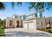 Charming exterior showcases a two-car garage, arched doorway, and white brick at 985 Shipmaster Ave., Myrtle Beach, SC 29579