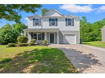 Charming two-story home with landscaped front yard, driveway, and attached one-car garage at 101 Winding Path Dr., Loris, SC 29569