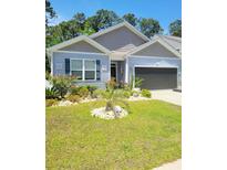 Charming home featuring beautiful landscaping, flowering plants, and a well-maintained lawn at 1011 Maxwell Dr., Little River, SC 29566