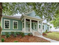 Charming home with a welcoming front porch featuring white columns and a well-manicured lawn at 1400 James Island Ave., North Myrtle Beach, SC 29582