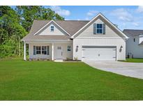 Charming one-story home with a well-manicured lawn and inviting front porch at 1503 Red Bluff Rd., Loris, SC 29569