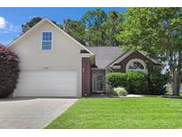 Charming single-Gathering home featuring a manicured lawn, neutral siding, and a two-car garage at 2302 Clandon Dr., Myrtle Beach, SC 29579
