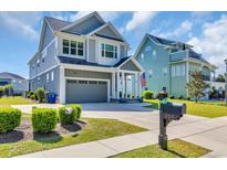Charming two-story home boasts a manicured lawn and inviting curb appeal at 260 Palmetto Harbour Dr., North Myrtle Beach, SC 29582