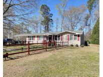 Charming ranch home with a red-picket fence and spacious front yard at 2917 Chippenham Rd., Marion, SC 29571