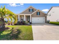 Charming single-Gathering home featuring a well-manicured lawn and an attached two-car garage at 315 Cattle Drive Circle, Myrtle Beach, SC 29588