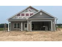 New construction gray home featuring an attached two-car garage and covered porch at 3597 Valley Forge Rd., Aynor, SC 29511