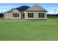 Charming one-story home featuring a well-manicured lawn, black shutters, and neutral siding under a brilliant blue sky at 3601 Valley Forge Rd., Aynor, SC 29511