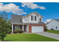Charming two-story home with a brick and siding facade, attached garage, and well-manicured lawn at 417 Pennington Loop, Myrtle Beach, SC 29588