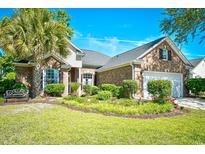 Charming brick home featuring a lush landscaped front yard, palm tree, and inviting bench at 5813 Mossy Oaks Dr., North Myrtle Beach, SC 29582