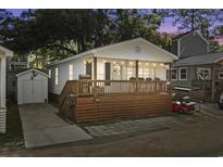 Charming coastal home featuring a spacious wooden deck and a cozy, inviting atmosphere with string lights at 6001 - 1433A S Kings Hwy., Myrtle Beach, SC 29575